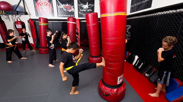 Kids martial arts training in a krav maga class at KRAV Zone martial arts gym.